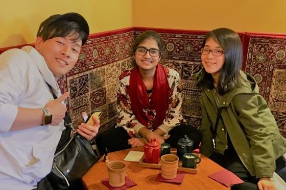 Photo of three international students posing in a Pittsburgh tea shop