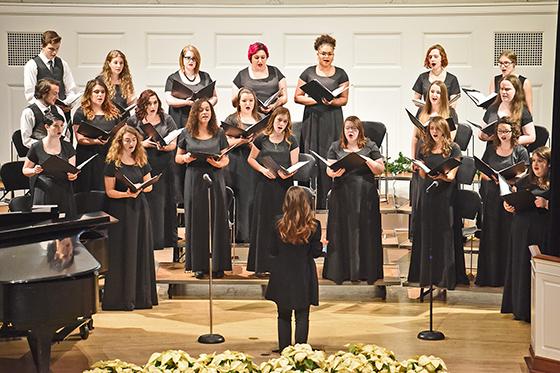 Photo of the Chatham Choir in formalwear, performing at Candlelight in the Chapel